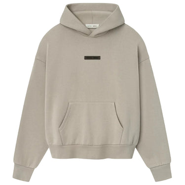 Beige hoodie with a small logo on a light gray background