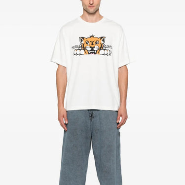 Person wearing a white t-shirt with a graphic design and blue jeans on a white background